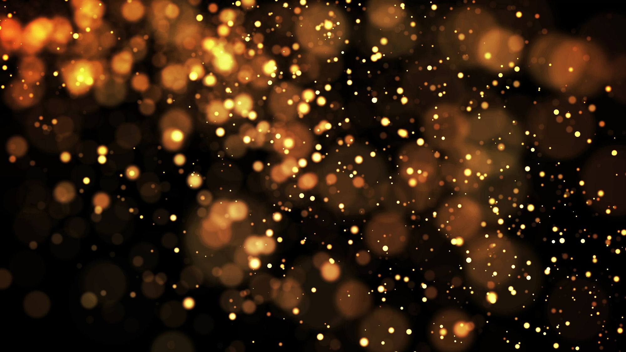 Gold sparkles of light on a black background