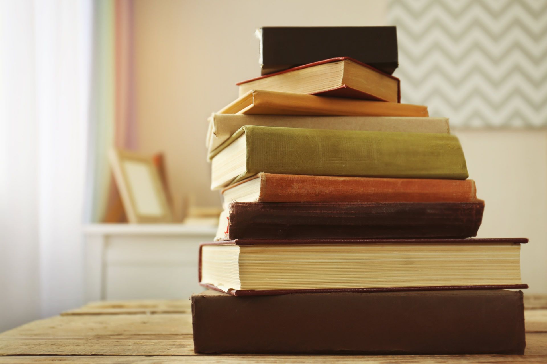 A pile of books on a table. 